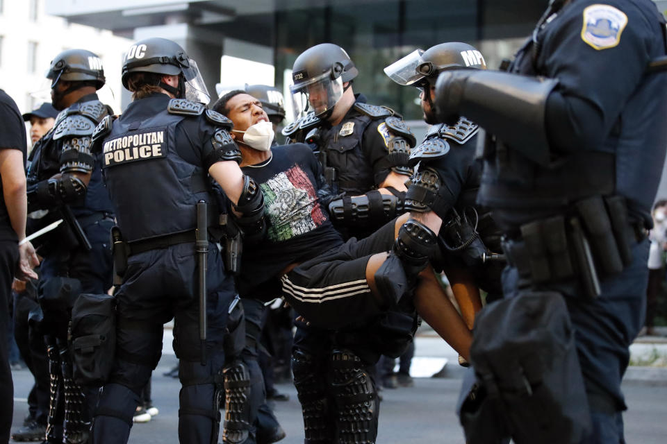 A demonstrator is taken into custody by police after a curfew took effect during a protest over the death of George Floyd, Monday, June 1, 2020, near the White House in Washington. Floyd died after being restrained by Minneapolis police officers. (AP Photo/Alex Brandon)