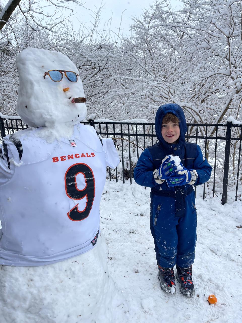 Carter Haas, 5, of Mount Lookout built stands with “Snow Burrow” outside his Mount Lookout home Sunday. His father Laurence Haas said the snow is perfect for building “Snow Burrows” all over the city.