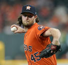 FILE - In this Sept. 21, 2018, file photo, Houston Astros starting pitcher Gerrit Cole throws against the Los Angeles Angels during the first inning of a baseball game in Houston. AL MVP Mookie Betts, NL Cy Young Award winner Jacob deGrom and major league home run champion Khris Davis reached high-priced one-year deals to avoid salary arbitration, while slugger Nolan Arenado and pitchers Cole, Luis Severino and Aaron Nola failed to reach agreements and for now appeared headed to hearings. (AP Photo/David J. Phillip, File)