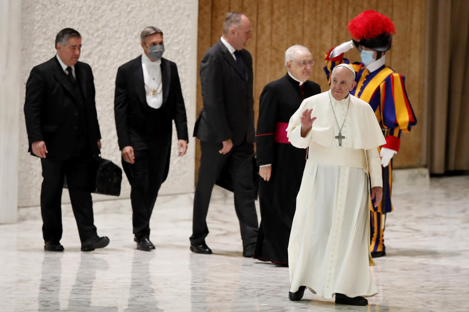 Pope Francis arrives in the Paul VI Hall at the Vatican for his weekly general audience, Wednesday, Oct. 28, 2020. Pope Francis has blamed “this lady COVID” for forcing him to keep his distance from the faithful during his general audience, which was far smaller than usual amid soaring coronavirus infections in Italy. (AP Photo/Alessandra Tarantino)