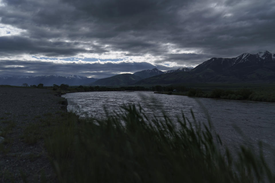 Floodwaters of the Yellowstone River flow through Emigrant, Mont., Wednesday, June 15, 2022. Historic floodwaters that raged through Yellowstone National Park may have permanently altered the course of a popular fishing river and left the sweeping landscape forever changed. (AP Photo/David Goldman)