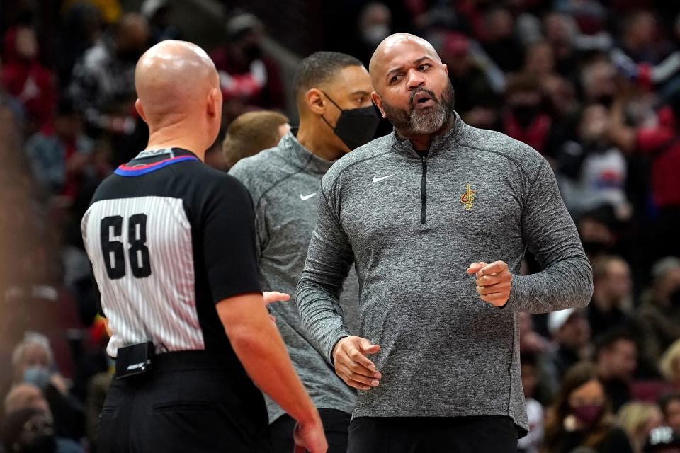 Cleveland Cavaliers coach J.B. Bickerstaff, right, talks with referee Jacyn Goble (68) during the first half of the team's NBA basketball game against the Chicago Bulls on Wednesday, Jan. 19, 2022, in Chicago. (AP Photo/Charles Rex Arbogast)