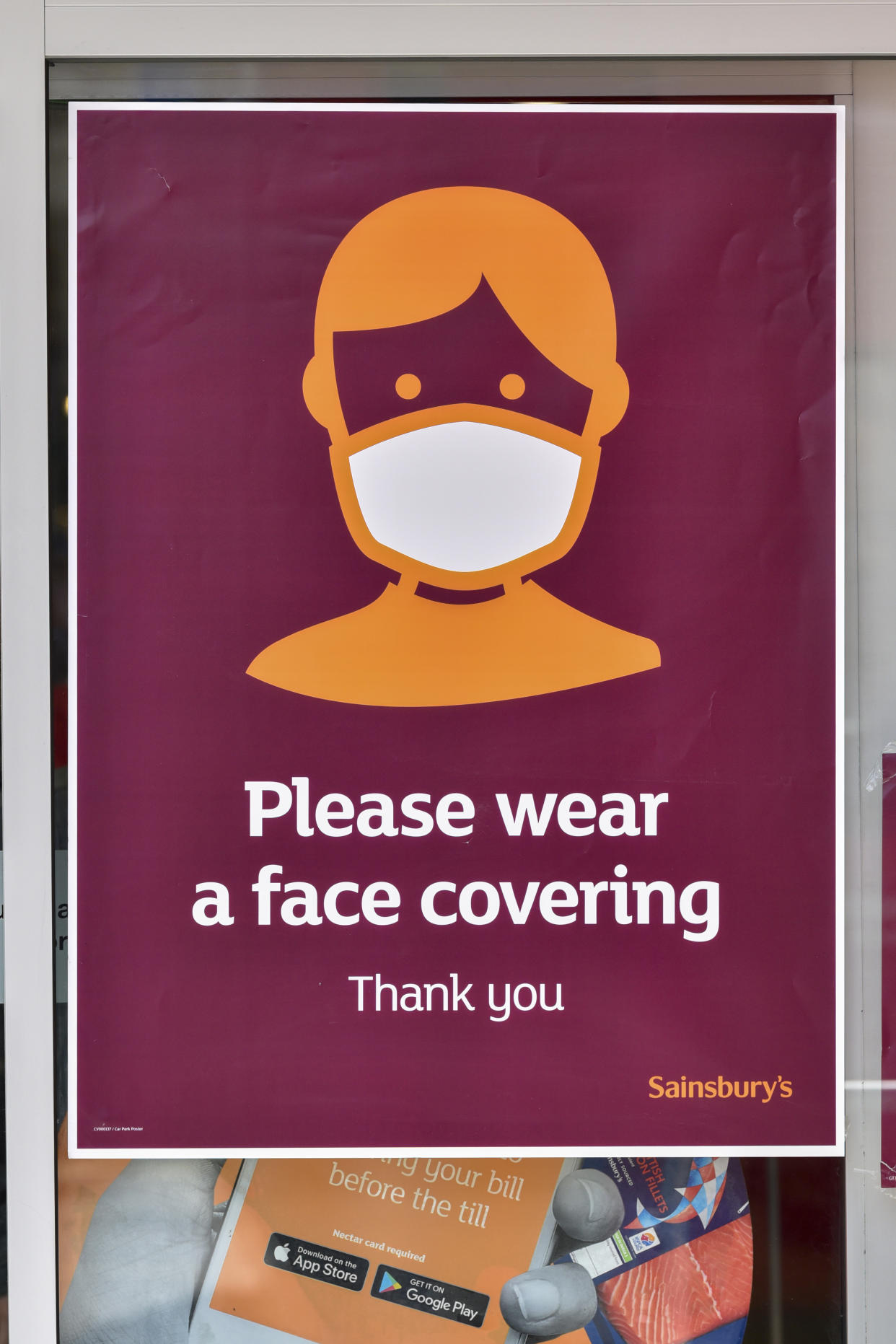 LONDON, UNITED KINGDOM - 2020/07/28: A sign advising customers to wear protective face covering is displayed at Sainsburys store. The Government has made it mandatory to wear face coverings on all public transport and in different places like shops, banks and post offices as well as shops, supermarkets, indoor shopping centres and stations in England. (Photo by Dave Rushen/SOPA Images/LightRocket via Getty Images)
