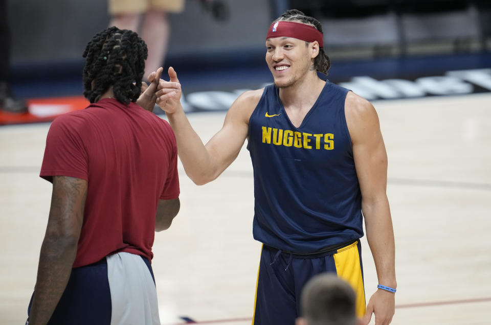 Denver Nuggets center DeAndre Jordan, left, greets forward Aaron Gordon as players take part in NBA basketball practice, Wednesday, May 31, 2023, in Denver. The Warriors take on the Miami Heat in Game 1 of the NBA Finals on Thursday. (AP Photo/David Zalubowski)