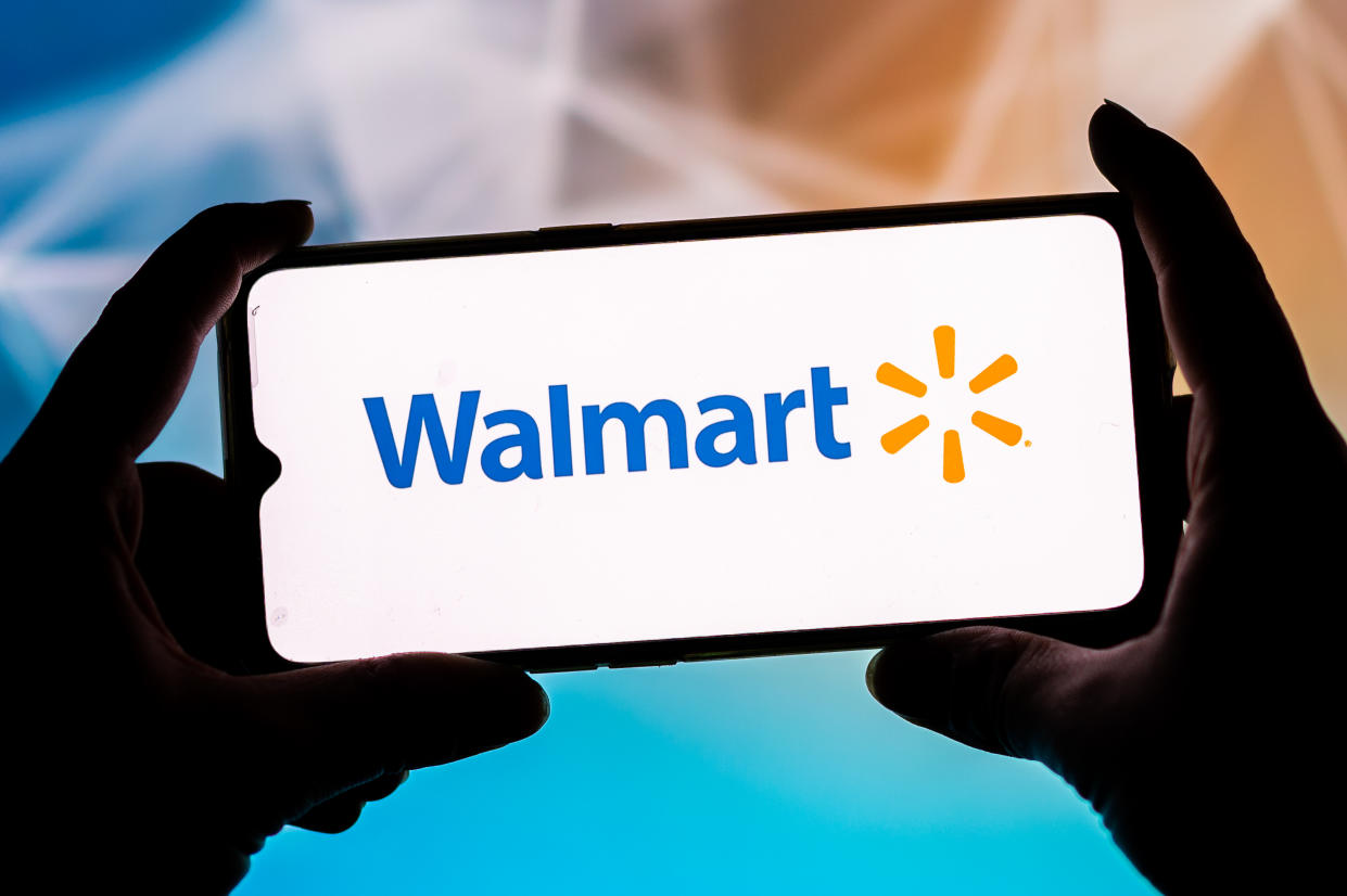 Walmart logo on a smartphone held by woman.