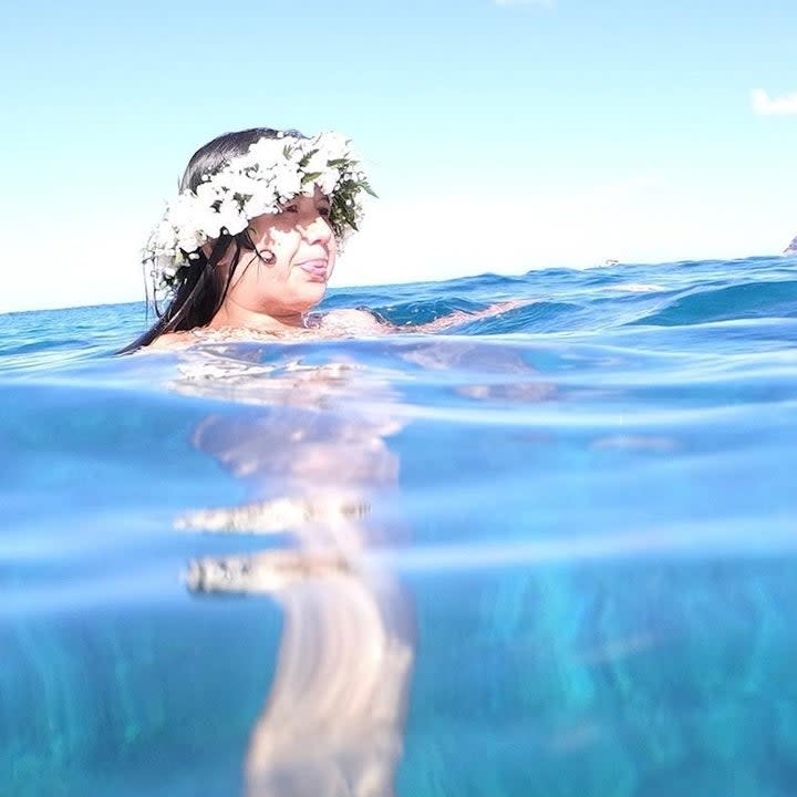 Casey with a flower crown as she floats in the water