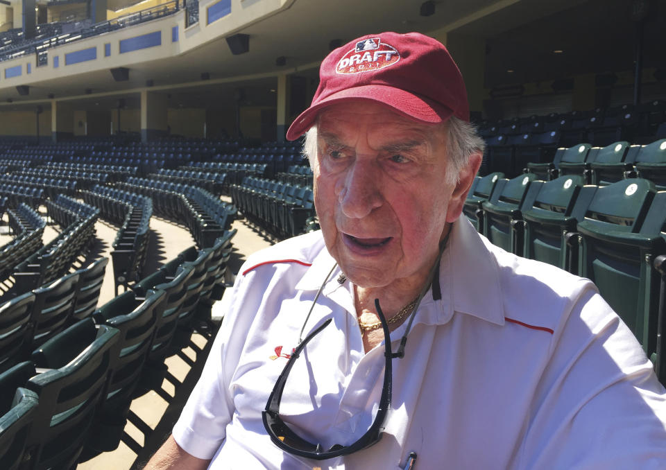 FILE - In this Martch 6, 2016, file photo, Tommy Giordano, special assistant to the general manager of the Atlanta Braves, sits in the stands after the team's spring training baseball workout, in Kissimmee, Fla. T-bone (a nickname that goes back to his days growing up in New Jersey, when his father would always make him a steak as a pregame meal) had every intention of coming back for his 72nd season _ staked out behind home plate, a stopwatch in one hand, a lineup card in his lap. (AP Photo/Paul Newberry, File)