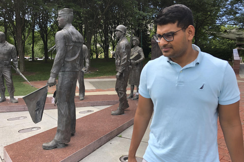 In this June 26, 2019 photo, Ashish Bibireddy, 23, tours a war memorial at Cumberland Square Park in Bristol, Va. Ten medical students were on a tour of the city organized by a medical school with the aim of luring them to practice in rural communities facing health care shortages after graduation. (AP Photo/Sudhin Thanawala)