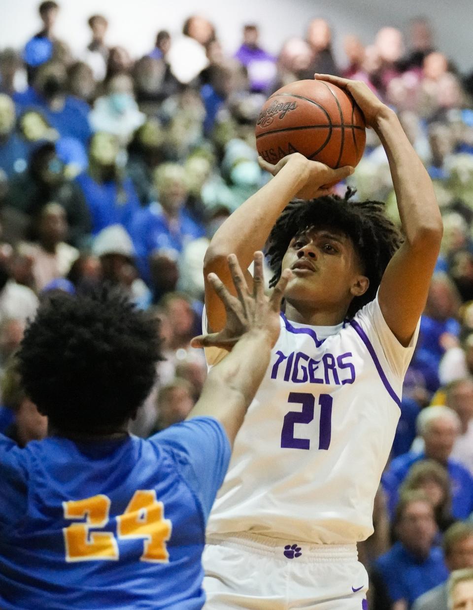 Sat., Mar. 12, 2022; Columbus, Ohio, USA; Pickerington Central forward Devin Royal (21) shoots a jump shot over Gahanna Lincoln Lions forward Javan Simmons (24) during the second quarter of a OHSAA Boys' Basketball regional final between the Pickerington Central Tigers and the Gahanna Lincoln Lions at Ohio Dominican University Alumni Hall.