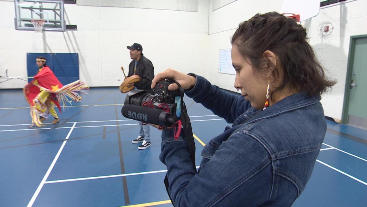 Tristin Greyeyes, right, is the executive director of the Ācimowin Film Festival taking place this week in Saskatoon. (Travis Reddaway/CBC - image credit)