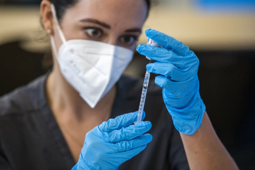 WILMINGTON, CA - JULY 27: Nursing student Brittany Corlyn is drawing medicine into a syringe at a vaccination clinic at the Providence Wellness and Activity Center on Tuesday, July 27, 2021 in Wilmington, CA. Escalating COVID-19 cases are threatening a new surge in Southern California . Providence is holding three-day COVID-19 vaccine clinic in Wilmington for people 12 years old and up. (Francine Orr / Los Angeles Times)