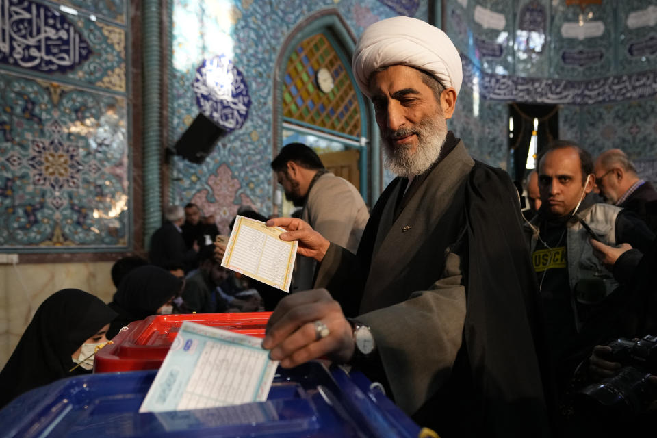 A cleric casts his ballot during the parliamentary and Assembly of Experts elections at a polling station in Tehran, Iran, Friday, March 1, 2024. Iran began voting Friday in its first elections since the mass 2022 protests over its mandatory hijab laws after the death of Mahsa Amini, with questions looming over just how many people will turn out for the poll. (AP Photo/Vahid Salemi)