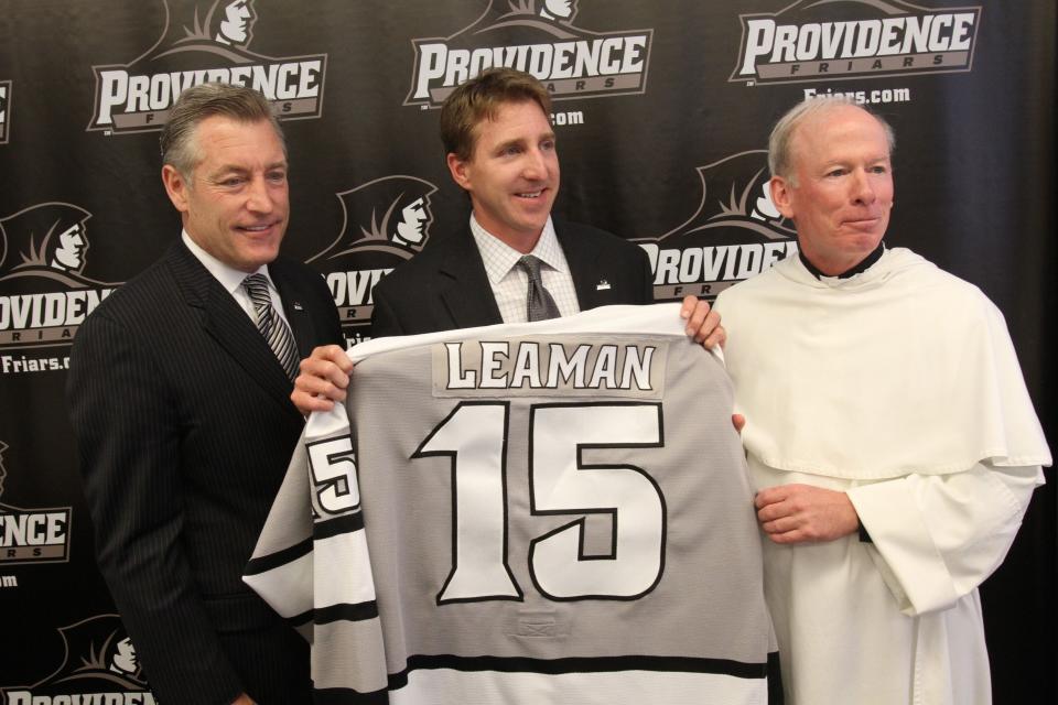 Athletic Director Bob Driscoll, left, introduces Nate Leaman as the Friars men's hockey coach in 2011. Also pictured is then-PC President Rev. Brian Shanley. Driscoll is retiring after 20 years in Providence.