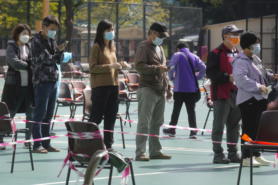 Residents wait to be tested for the coronavirus at a temporary testing center in Hong Kong, Monday, Feb. 28, 2022. (AP Photo/Vincent Yu)