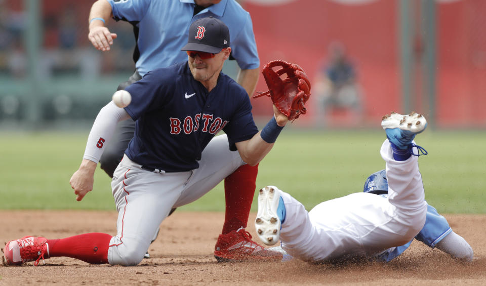 Boston Red Sox second baseman Enrique Hernandez, left, catches a late throw as Kansas City Royals' Whit Merrifield, right, steals second base in the first inning of a baseball game at Kauffman Stadium in Kansas City, Mo., Saturday, June 19, 2021. (AP Photo/Colin E. Braley)