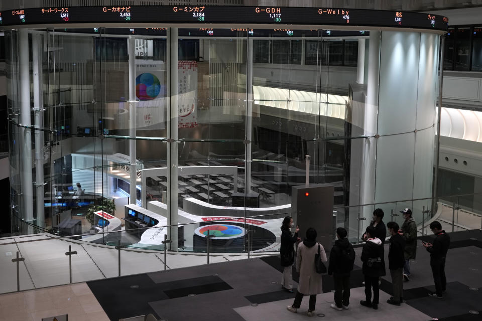 Visitors are seen at the Tokyo Stock Exchange on Dec. 12, 2022, in Tokyo, Japan. Shares rose Monday Dec. 26, 2022, in Asia in thin post-Christmas holiday trading, with markets in Hong Kong, Sydney and several other places closed.(AP Photo/Shuji Kajiyama)