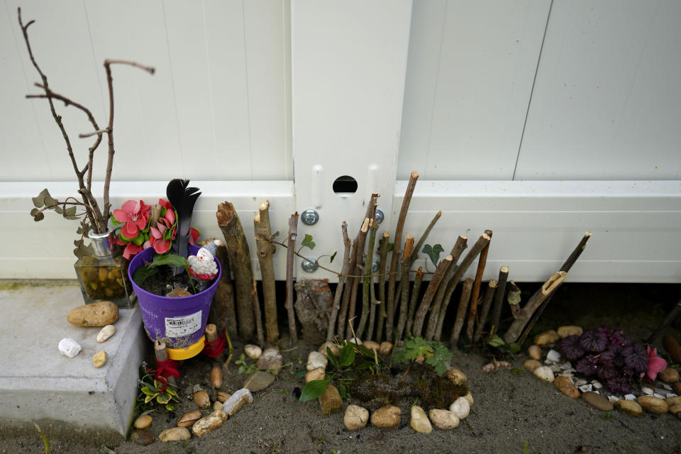 Sticks and flowers in a makeshift garden at the Ukraine village, which has been constructed for Ukrainian families fleeing the war, in Linkeroever, Belgium, Friday, March 17, 2023. Despite the warm welcome for millions of Ukraine refugees on European Union soil since the Russian invasion, EU officials said Tuesday, June 6, 2023 that there are some fears of wavering support caused by a bad economy hitting poor families especially and the creeping influence of Russian propaganda. (AP Photo/Virginia Mayo)