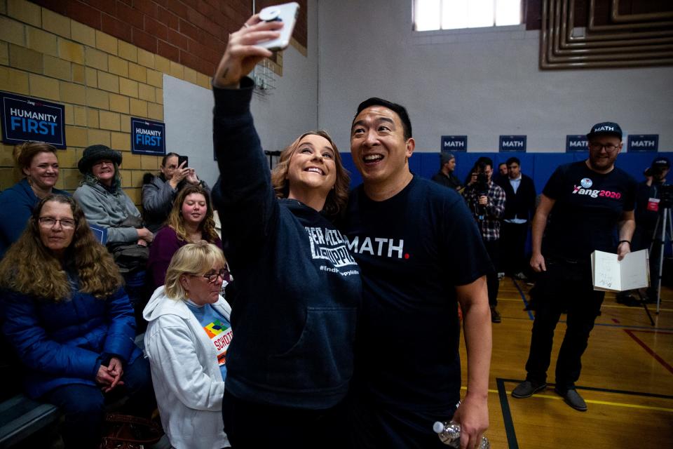 Democratic Presidential Candidate Andrew Yang poses for a selfie with Mindi Callison, of Ames, after playing a three-on-three basketball game on Thursday, Dec. 12, 2019, at the Ames Community Center. 