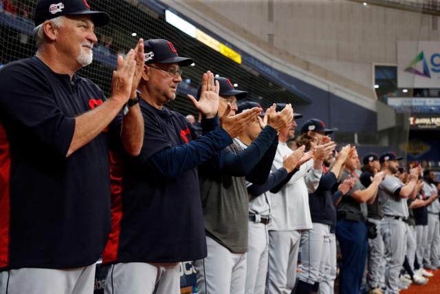 Sep 1, 2019; St. Petersburg, FL, USA; Cleveland Indians pitching coach Carl Willis (51), Cleveland Indians manager Terry Francona (77) and teammates stand as pitcher Carlos Carrasco (59) comes in to pitch for the first time since he was diagnosed with leukemia at Tropicana Field. Mandatory Credit: Kim Klement-USA TODAY Sports