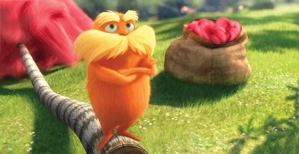 The Lorax crossing his arms while stanging on a fallen tree stump