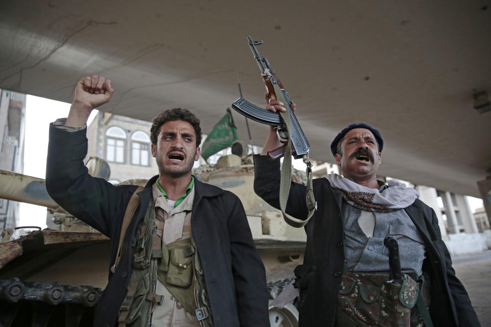 FILE - In this Dec. 4, 2017, file photo, Houthi Shiite fighters chant slogans as they guard a street leading to the residence of former Yemeni President Ali Abdullah Saleh, in Sanaa, Yemen. A senior leader from Yemen’s Houthi rebels says that for the sake of peace efforts the group will halt rocket fire into Saudi Arabia, its larger northern neighbor who is leading a U.S.-backed Arab coalition to restore Yemen’s internationally recognized government. (AP Photo/Hani Mohammed, File)