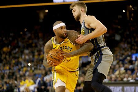 Mar 21, 2019; Oakland, CA, USA; Golden State Warriors center DeMarcus Cousins (0) attempts to drive past Indiana Pacers forward Domantas Sabonis (11) in the fourth quarter at Oracle Arena. Mandatory Credit: Cary Edmondson-USA TODAY Sports