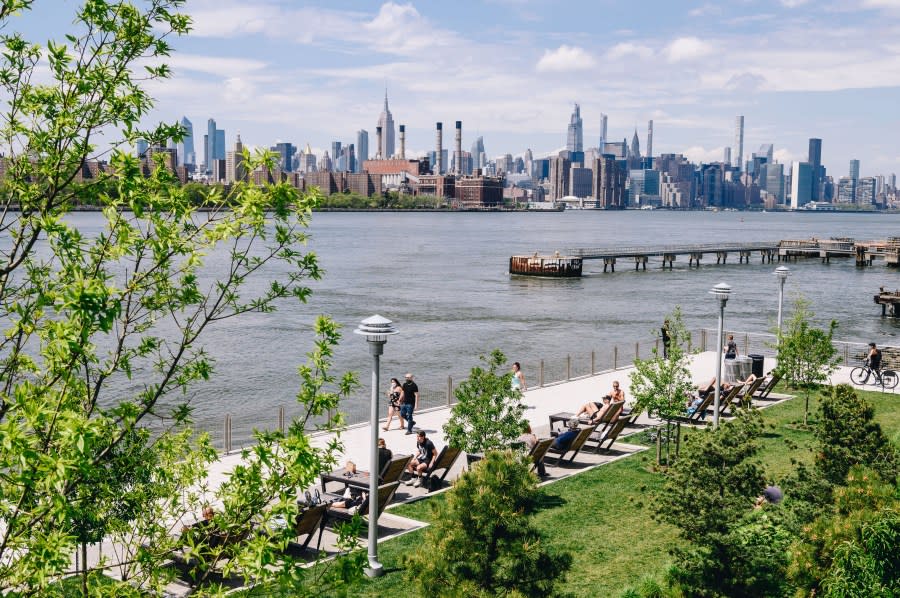 People lay on lounge chairs at Domino Park in the Brooklyn Borough of New York, U.S., on Friday, May 15, 2020. (Credit: Nina Westervelt/Bloomberg via Getty Images)