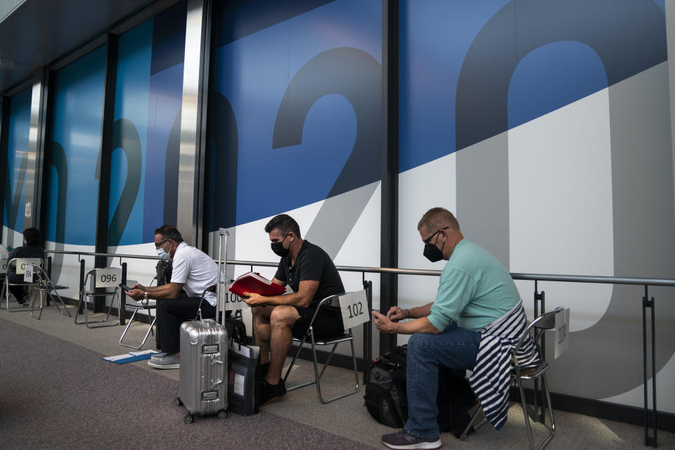 Foreign visitors wait in the holding area to take a COVID-19 test at the Narita International Airport on July 10, 2021, in Narita, near Tokyo. Japan’s massive security apparatus for the upcoming Summer Olympics is raising complaints that the nation, during the weeks of the Games, will look more like authoritarian North Korea or China than one of the world’s most powerful, vibrant democracies. (AP Photo/Jae C. Hong)