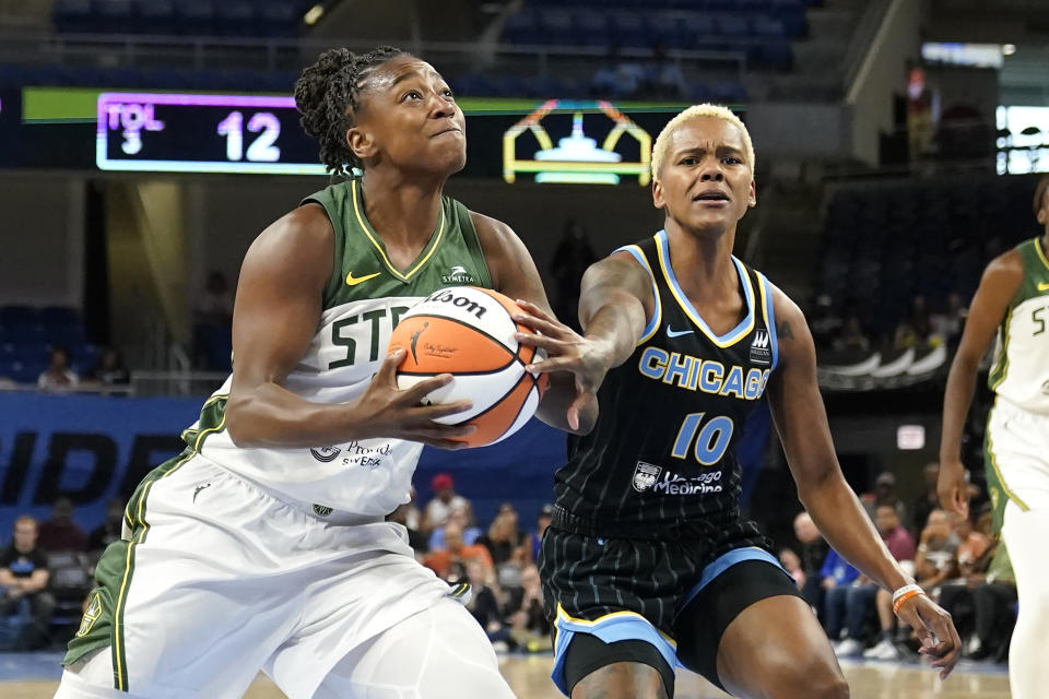 Seattle Storm's Jewell Loyd (24) drives to the basket as Chicago Sky's Courtney Williams defends during the first half of a WNBA basketball game Friday, July 28, 2023, in Chicago. (AP Photo/Charles Rex Arbogast)