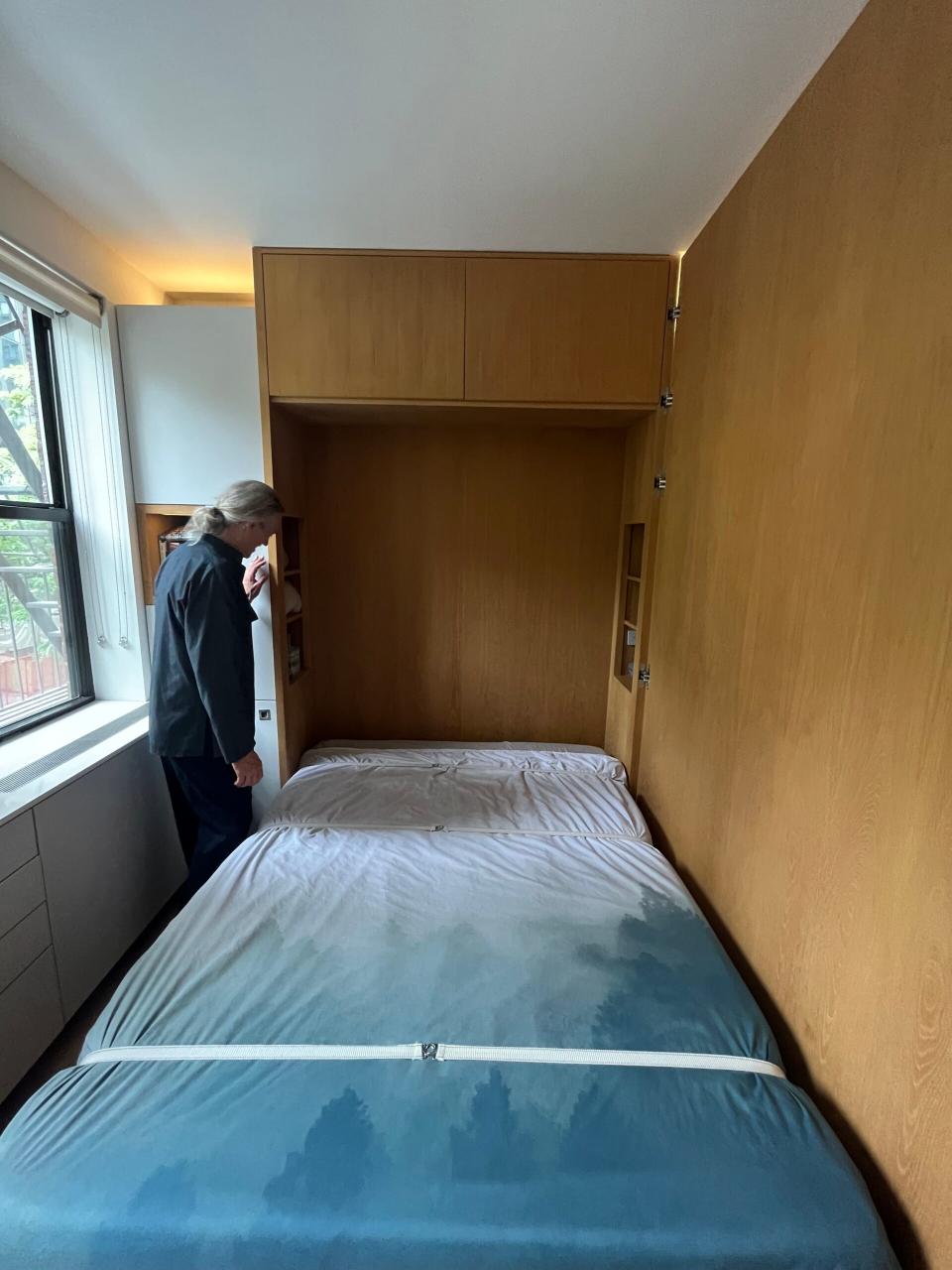 A bed with blue sheets lays perfectly flat in the newly opened bedroom. 