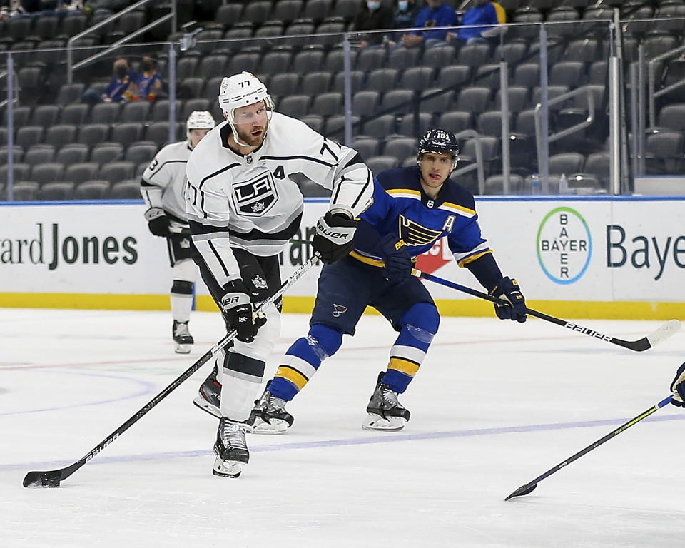 Los Angeles Kings' Jeff Carter (77) handles the puck next to St. Louis Blues' Brayden Schenn (10) during the first period of an NHL hockey game Wednesday Feb. 24, 2021, in St. Louis. (AP Photo/Scott Kane)
