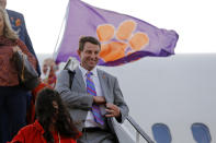 Clemson head coach Dabo Swinney and his wife Kathleen Swinney, bottom left, arrive with the team for the NCAA College Football Playoff national championship in New Orleans, Friday, Jan. 10, 2020. Clemson is to play LSU on Monday. (AP Photo/Gerald Herbert) (AP Photo/Gerald Herbert)