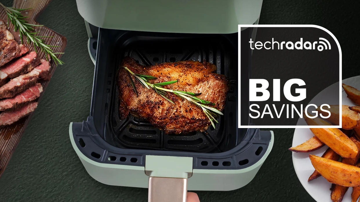  The Moosoo air fryer with its tray open revealing a cooked chicken. 