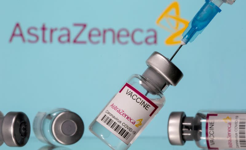 FILE PHOTO: Vials labelled "Astra Zeneca COVID-19 Coronavirus Vaccine" and a syringe are seen in front of a displayed AstraZeneca logo in this illustration photo