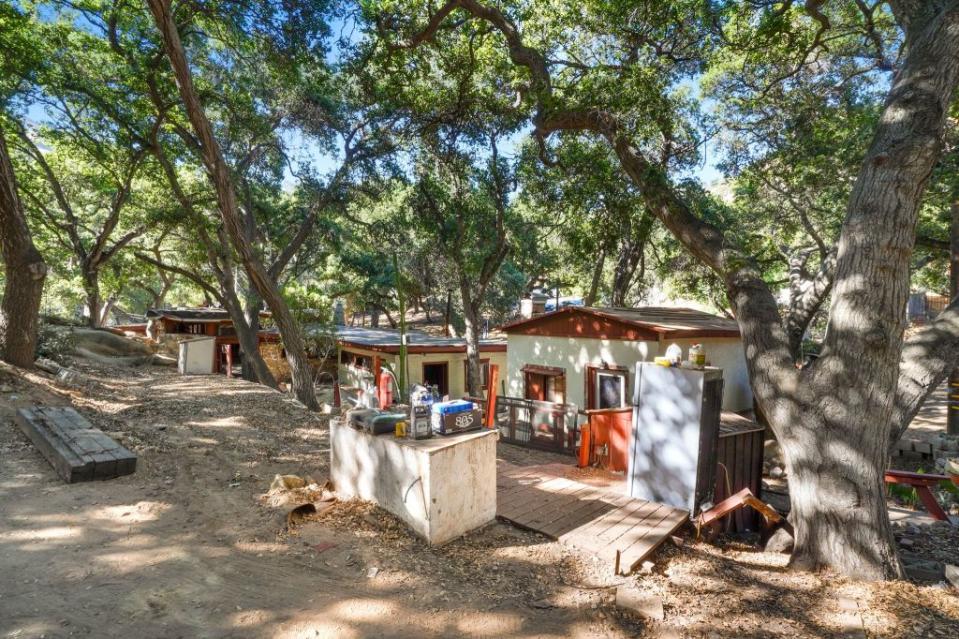 Existing structures on the land come shaded by trees. Holly & Chris Luxury Homes Group, Coldwell, Banker Calabasas