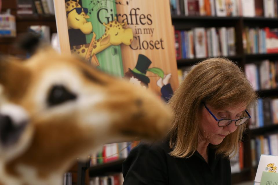 Author Debra Young Hatch signs copies of her children's book, "Giraffes in My Closet," at Barnes & Noble Friday, June 21, 2024.