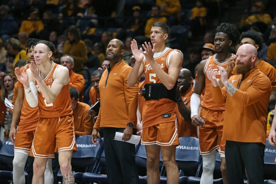 Texas players react from the bench during the second half of an NCAA college basketball game against West Virginia on Saturday, Jan. 13, 2024, in Morgantown, W.Va. (AP Photo/Kathleen Batten)