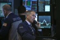 Traders work on the floor of the New York Stock Exchange February 19, 2014. REUTERS/Brendan McDermid