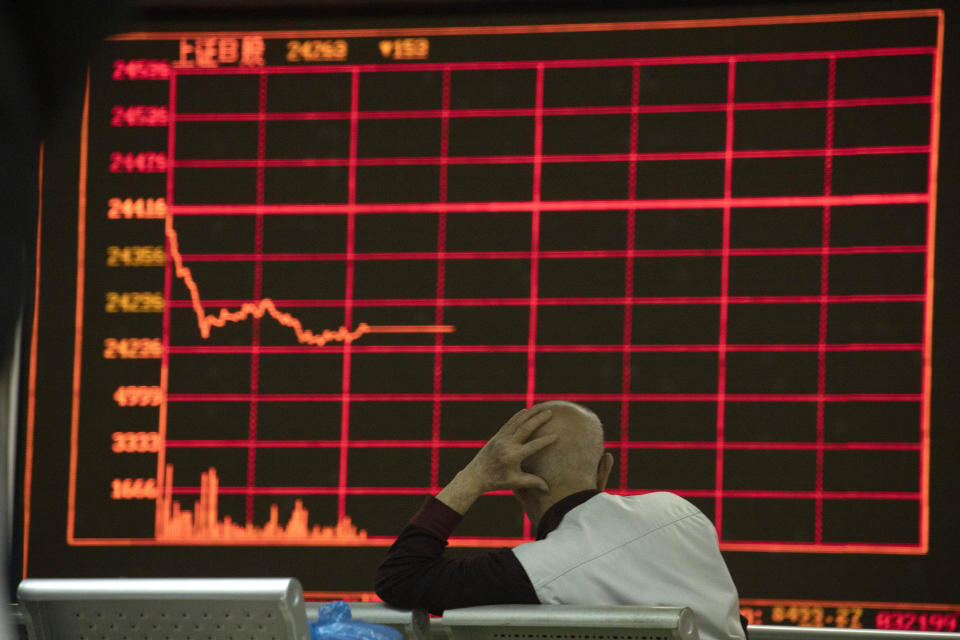 An investor monitors stock prices at a brokerage in Beijing on Thursday, Dec. 12, 2019. Asian shares are mixed after a wobbly day on Wall Street following the Federal Reserve announcement that it would leave interest rates unchanged. Japan's benchmark Nikkei 225, South Korea's Kospi and Hong Kong's Hang Seng rose in early Thursday trading. (AP Photo/Ng Han Guan)