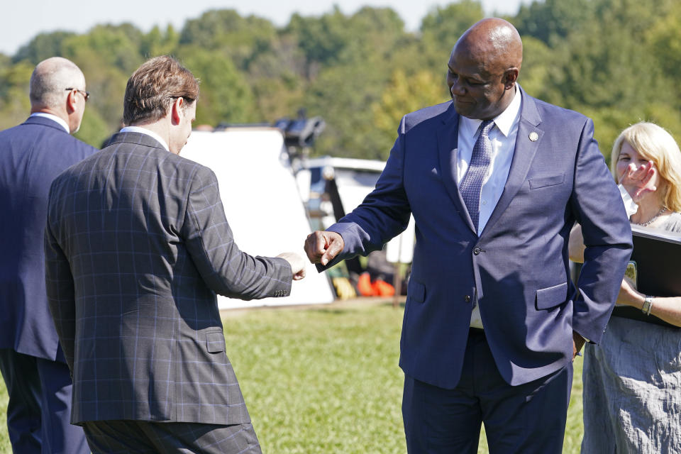 United Auto Workers President Ray Curry, right, bumps fists with Jim Farley, Ford president and CEO, left, after a presentation on the planned factory to build electric F-Series trucks and the batteries to power future electric Ford and Lincoln vehicles Tuesday, Sept. 28, 2021, in Memphis, Tenn. The plant in Tennessee is to be built near Stanton, Tenn. (AP Photo/Mark Humphrey)