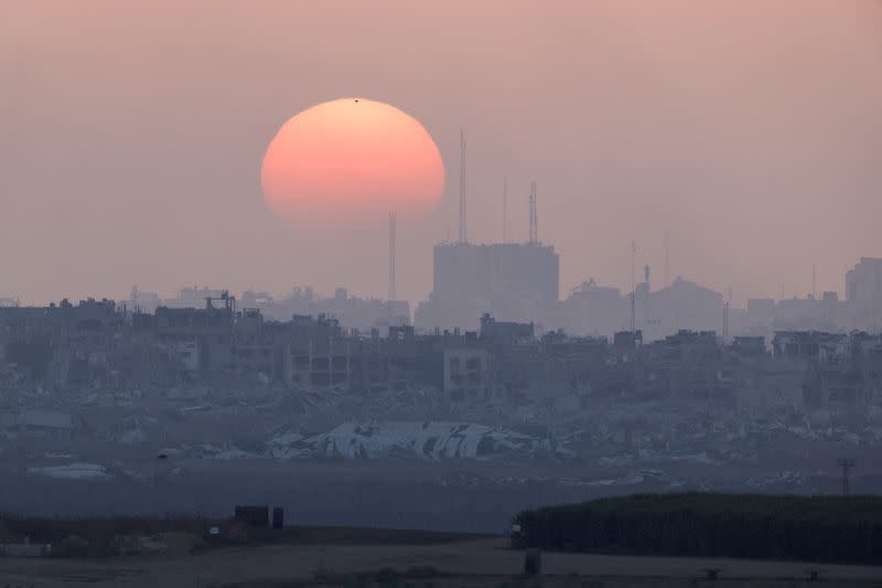 The sun sets over Gazas as seen from the border with Israel, amid the Israel-Hamas conflict, in Israel