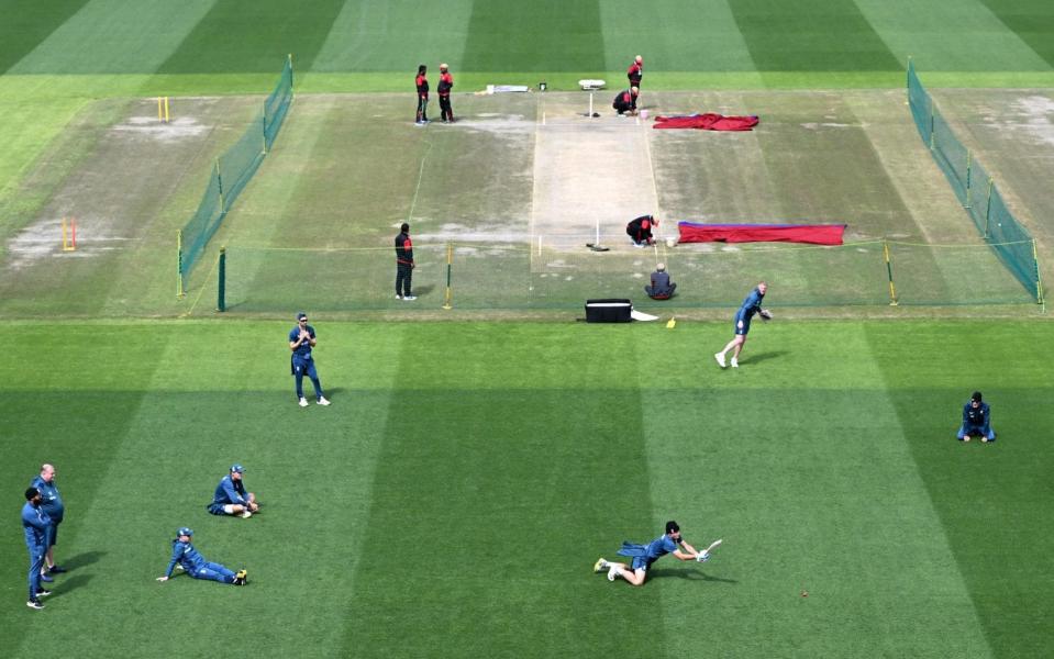 England train on the outfield as the pitch is prepared