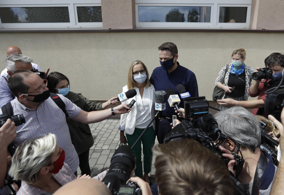 Presidential candidate Rafal Trzaskowski accompanied by his wife Malgorzata addresses media after casting his vote during the presidential election runoff in Rybnik, Poland, Sunday, July 12, 2020. Voting started Sunday in Poland's razor-blade-close presidential election runoff between the conservative incumbent Andrzej Duda and liberal, pro-European Union Warsaw Mayor Rafal Trzaskowski. (AP Photo/Petr David Josek)