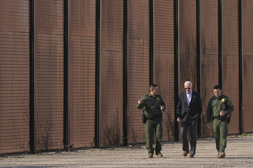 FILE - President Joe Biden walks with U.S. Border Patrol agents along a stretch of the U.S.-Mexico border in El Paso Texas, Sunday, Jan. 8, 2023. For the 12 months ending Sept. 30, 2022, U.S. Customs and Border Protection reported it stopped migrants at the U.S. border nearly 2.4 million times, a record surge driven by sharp increases in Venezuelans, Cubans and Nicaraguans making the trek. (AP Photo/Andrew Harnik, File)