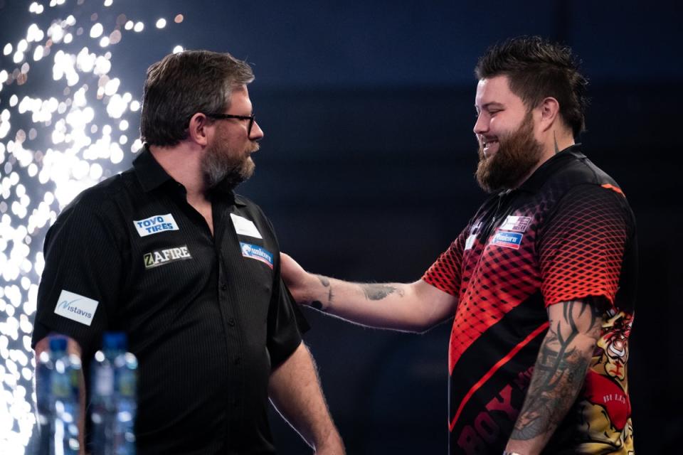 James Wade (left) and Michael Smith will go head to head again in Amsterdam on Sunday (Aaron Chown/PA) (PA Archive)