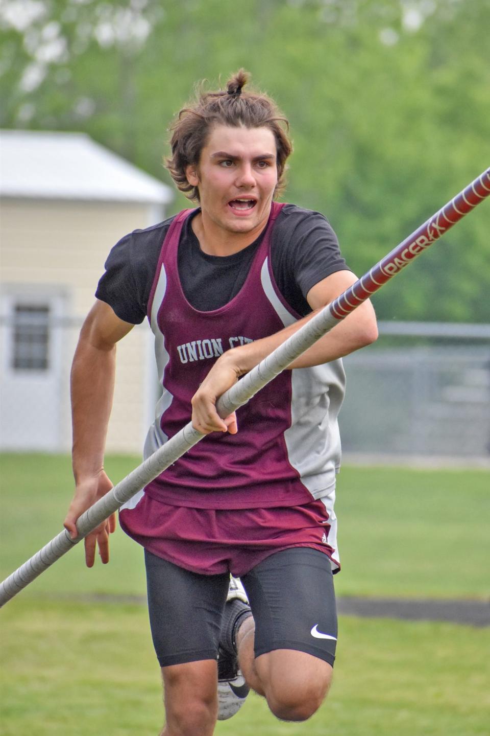 Union City's Alex Hull fought off a nagging ankle injury to win the conference title in the pole vault Wednesday night