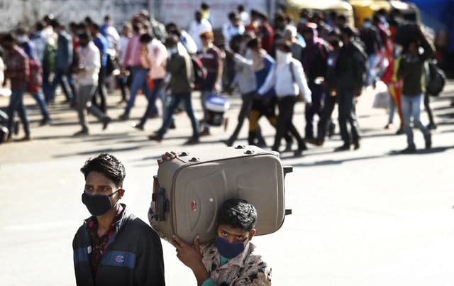 Migrant daily wage labourers make the journey to their respective villages on foot following a lockdown amid concern over the spread of coronavirus in New Delhi, India