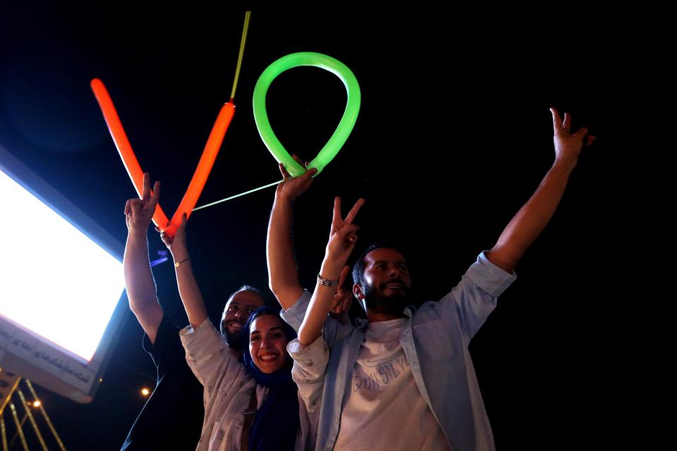 Iranians flash the V sign for victory during celebration in northern Tehran on July 14, 2015, after Iran's nuclear negotiating team struck a deal with world powers in Vienna. 