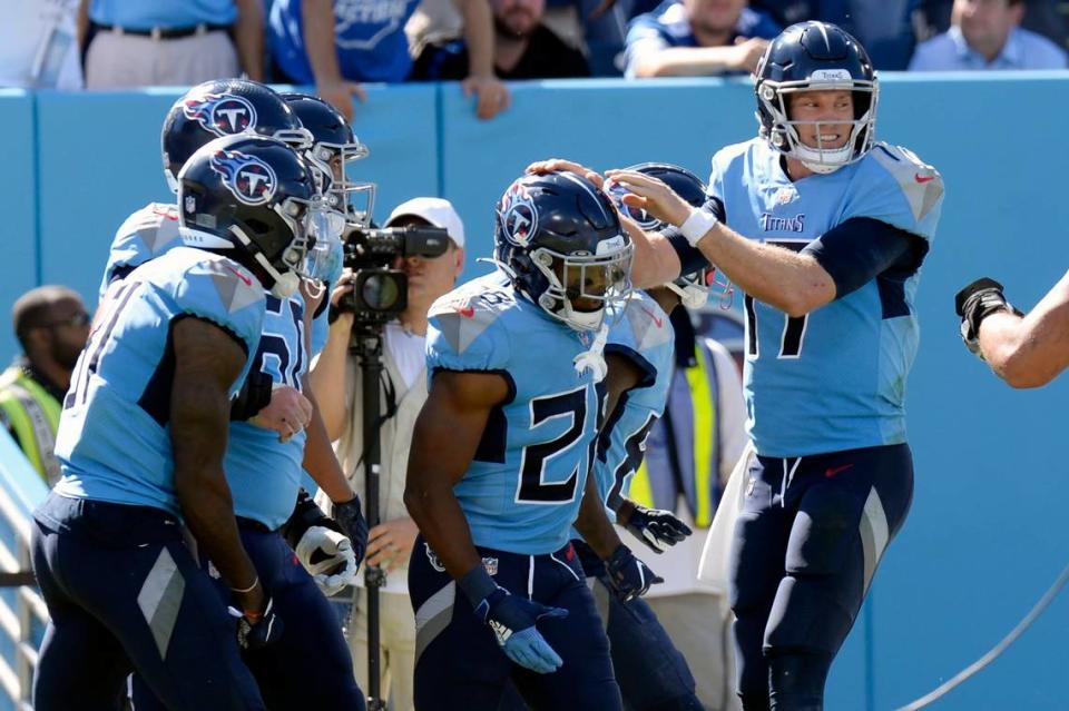 Tennessee Titans running back Jeremy McNichols, center, is congratulated by quarterback Ryan Tannehill, right, after they teamed up for a 10-yard touchdown pass against the Indianapolis Colts on Sunday in Nashville, Tenn.