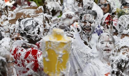 Students from St Andrews University are covered in foam as they take part in the traditional 'Raisin Weekend' in the Lower College Lawn, at St Andrews in Scotland, Britain October 17, 2016. REUTERS/Russell Cheyne